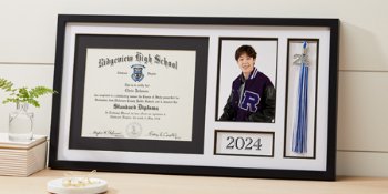 Grad holding Jostens class graduation keepsakes