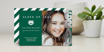 Graduate holding Jostens personalize photo card